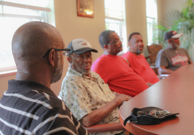 group of people sitting at a table having a conversation