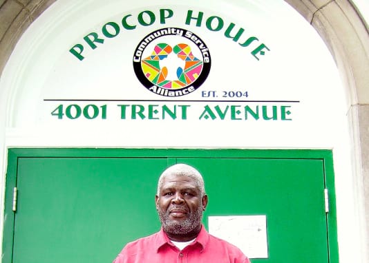 gentleman standing in front of procop house