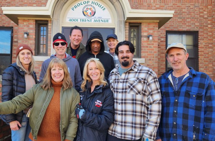 volunteers in front of CSA house