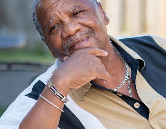 man sitting with his chin in his hand