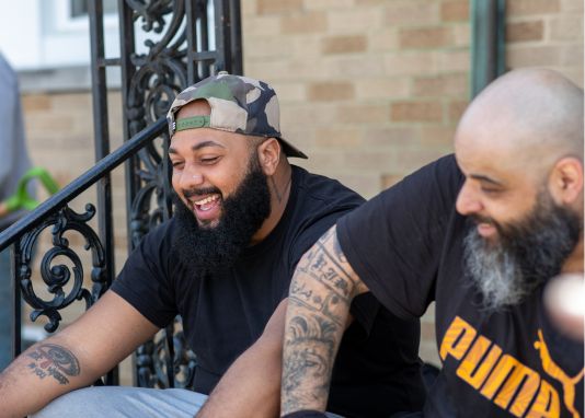 two men sitting together laughing